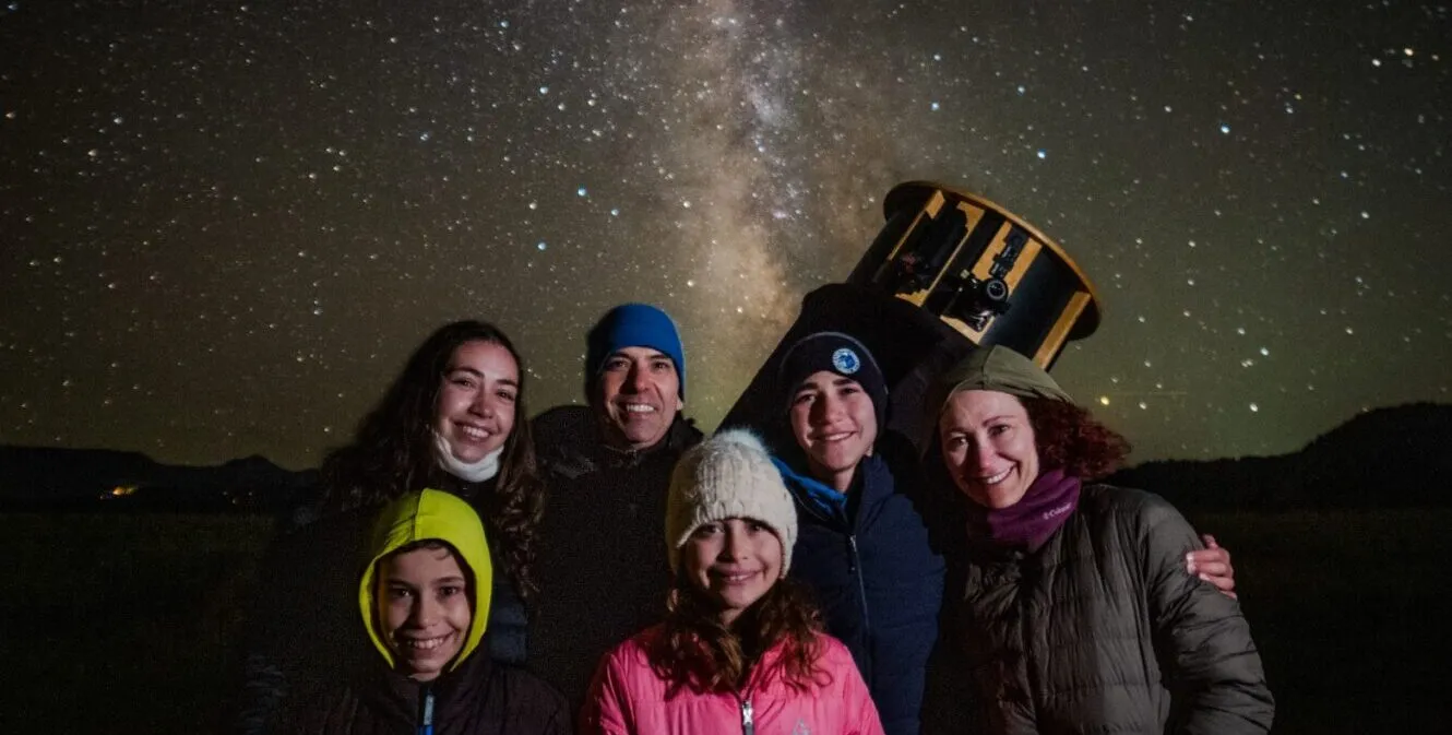 family in front of telescope
